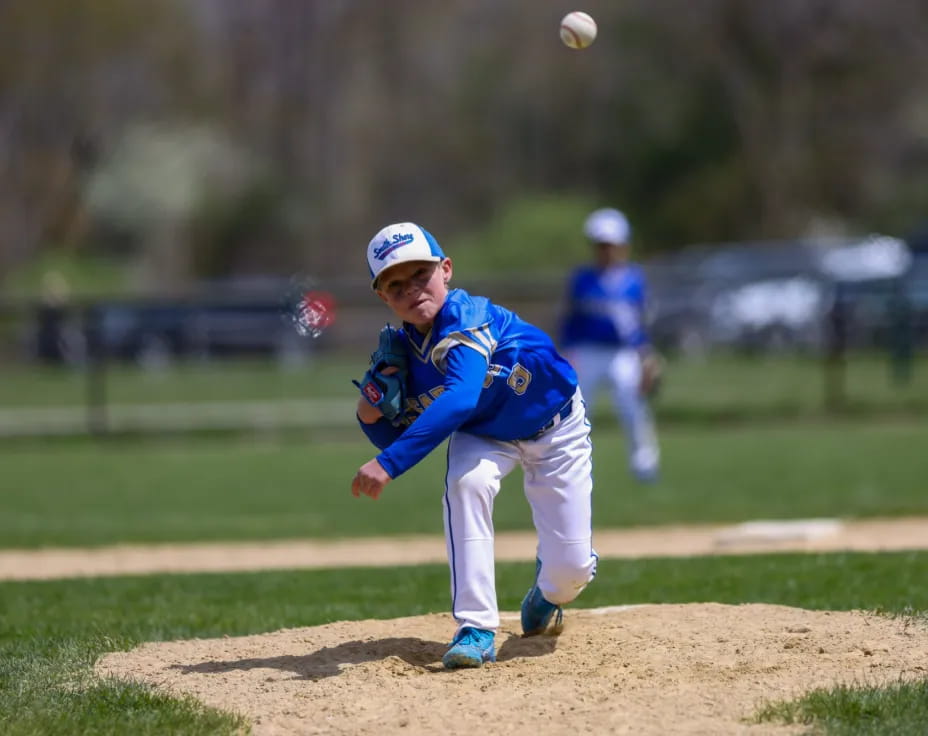 a kid throwing a baseball