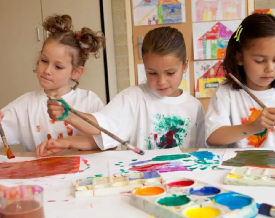 a group of children painting