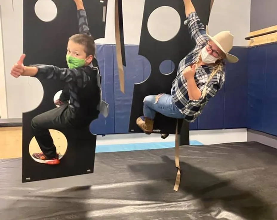 a person and a boy on a swing set