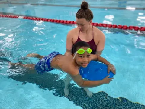a person and a boy in a pool
