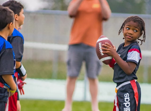 a girl holding a football