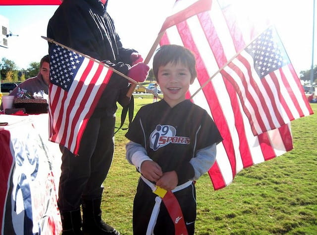 a boy holding a flag