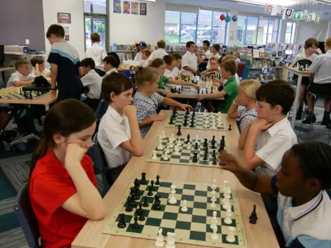 a group of children playing chess
