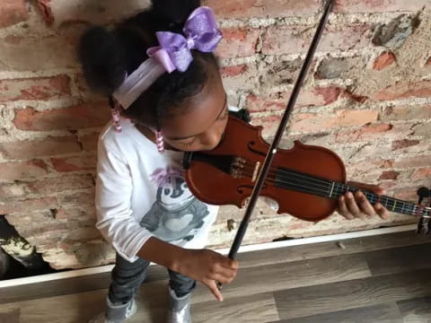 a girl playing a violin
