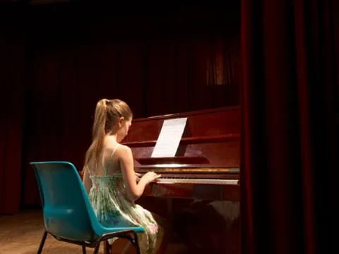 a person sitting at a piano
