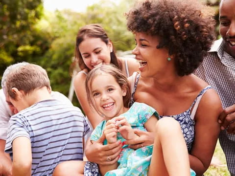a group of people holding a baby