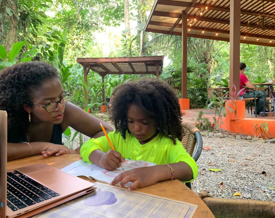 a person and a girl studying outside