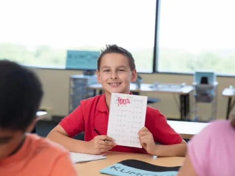a boy holding a paper