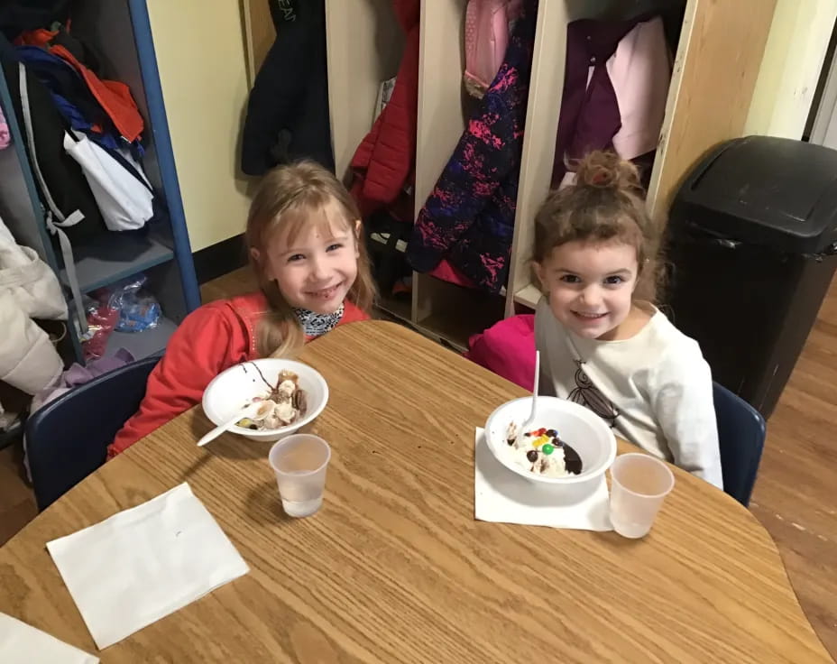 two girls sitting at a table