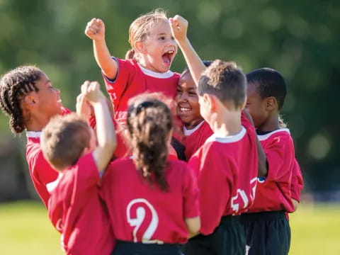 a group of people in red shirts