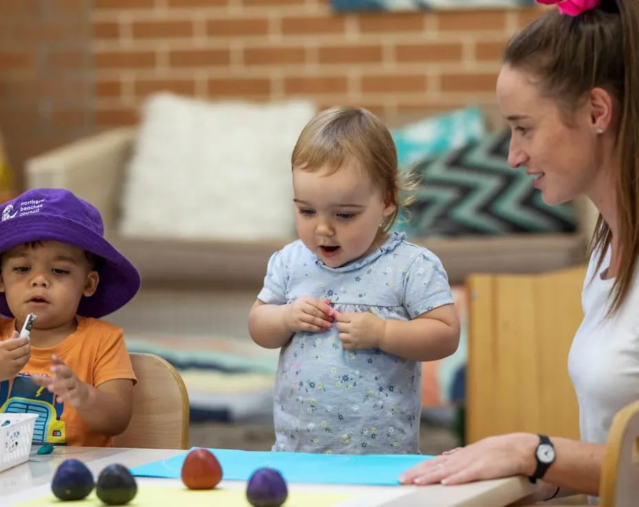 a person and two children eating