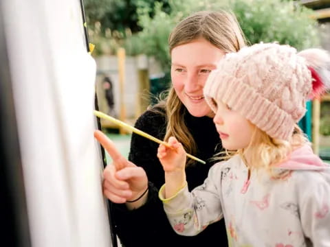 a person and a child painting