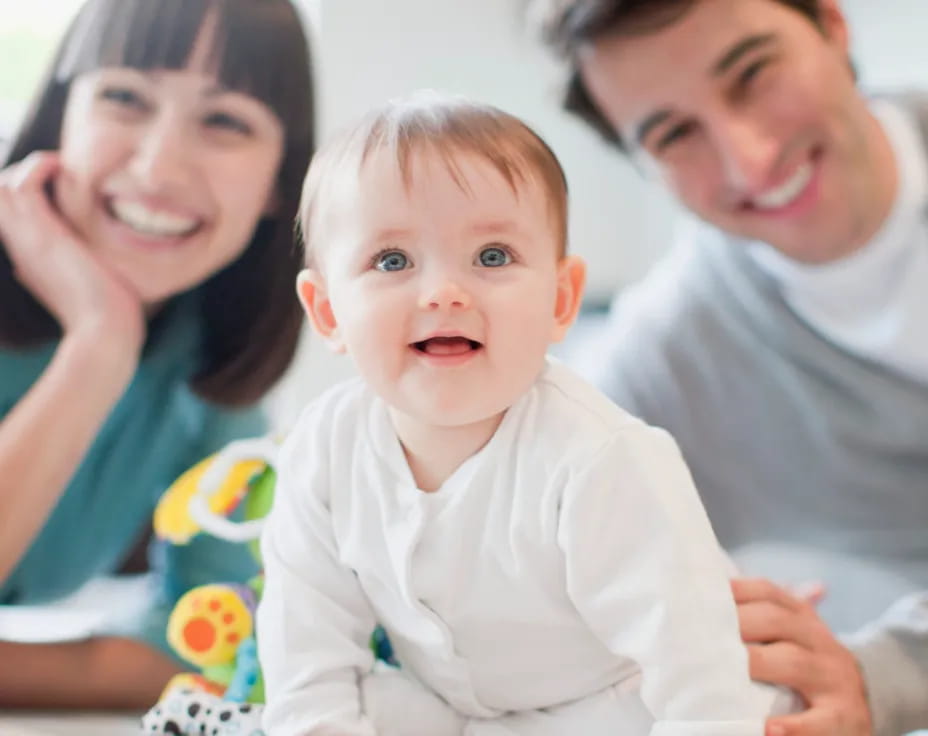 a man and woman with a baby