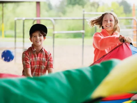 a boy and girl on a playground