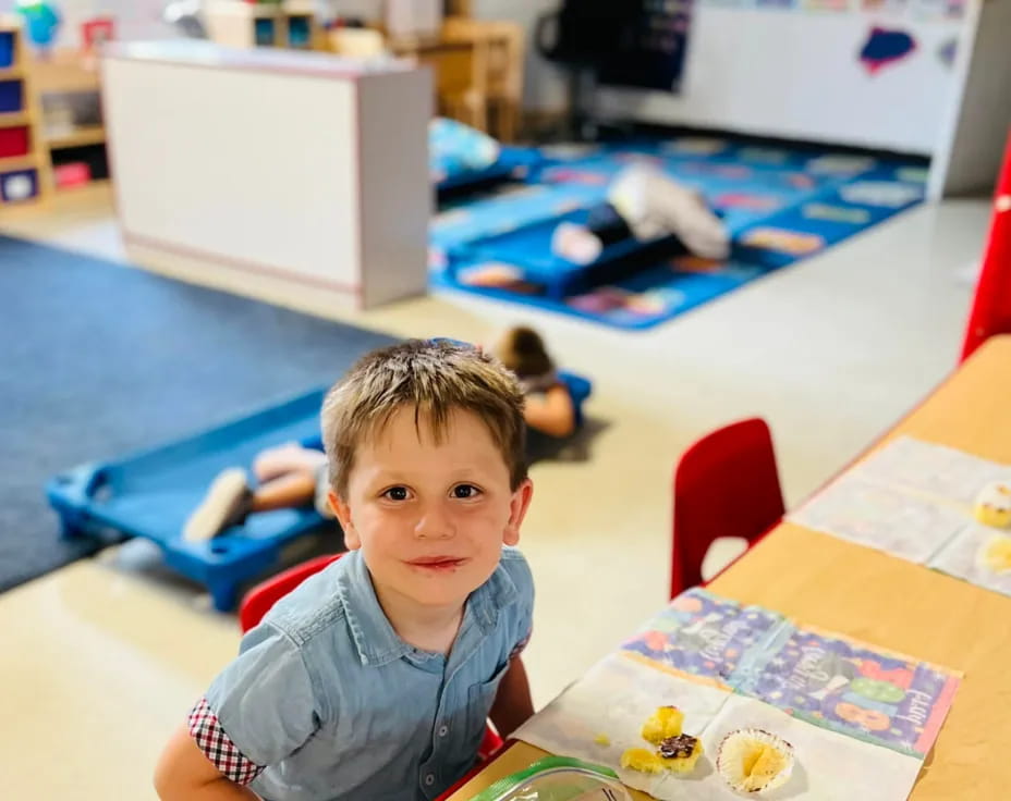 a boy sitting at a table