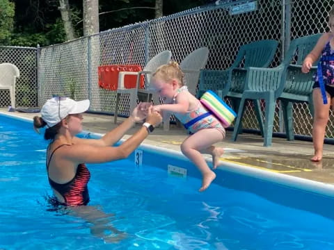 a boy and a girl in a pool