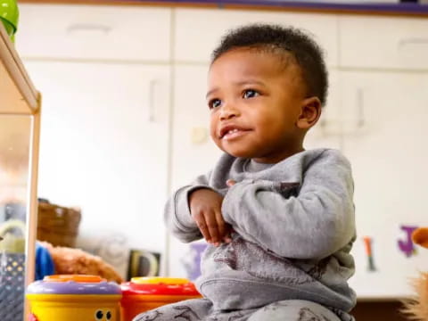 a baby in a gray sweater