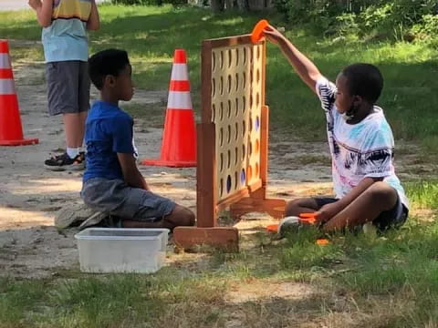 a group of kids playing with a toy