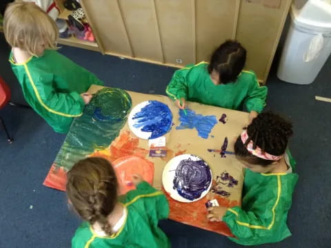 a group of children painting