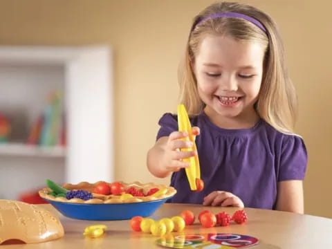 a little girl eating a banana