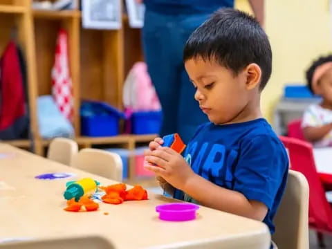 a young boy playing with toys