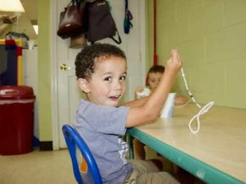 a young boy playing with a toy