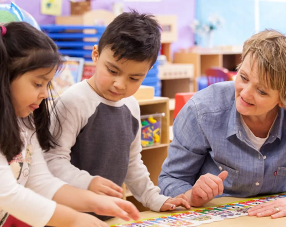 a group of children looking at a map
