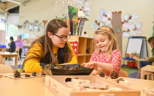 a young girl and a young girl playing a board game