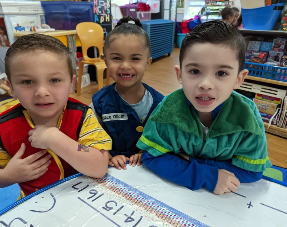 a group of boys sitting at a table
