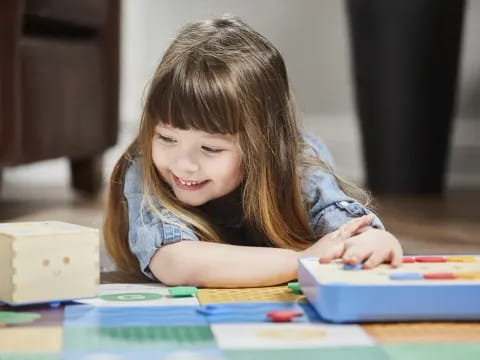 a young girl coloring on a table