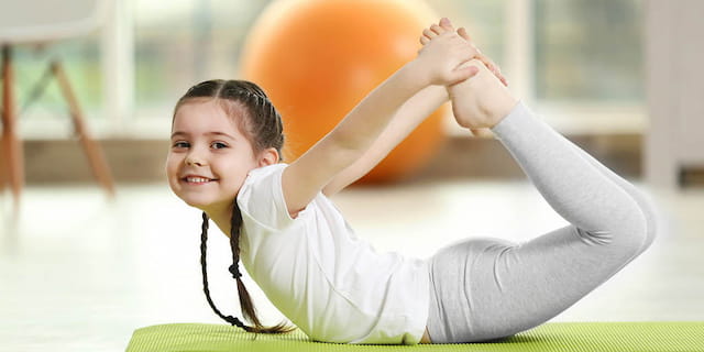 a young boy doing yoga