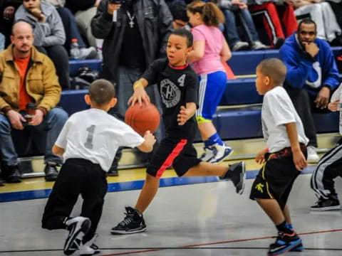 a group of kids playing basketball