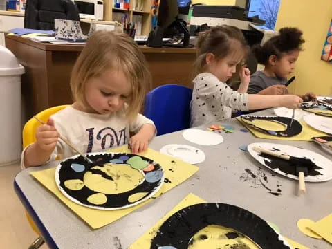 a group of children painting
