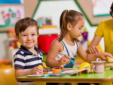 a few children sitting at a table