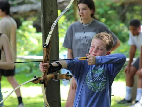 a boy holding a bow and arrow
