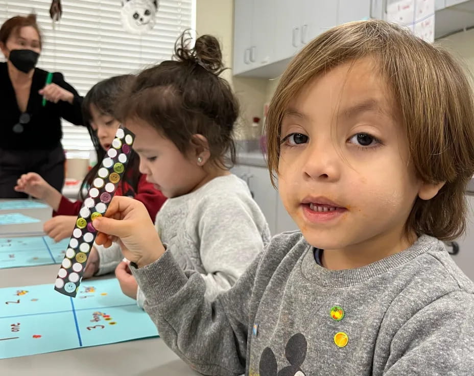 a young girl holding a toy