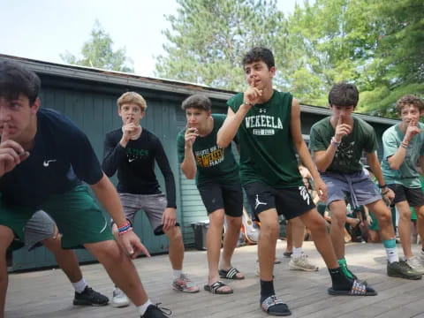 a group of men in green shirts