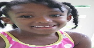 a boy smiling for the camera