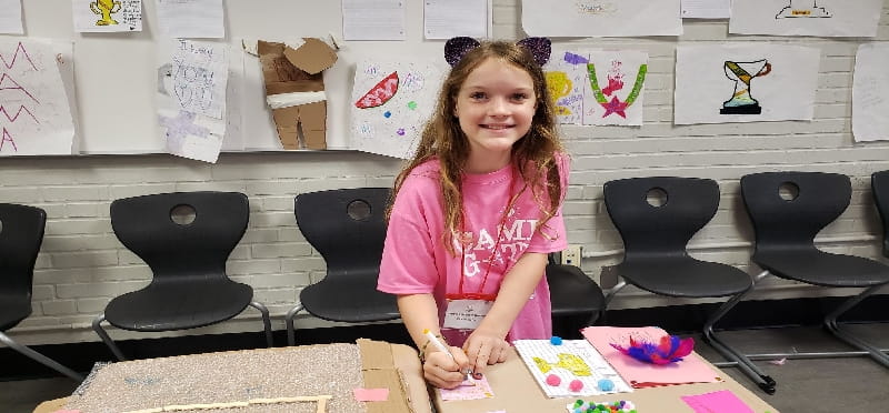 a girl sitting at a table