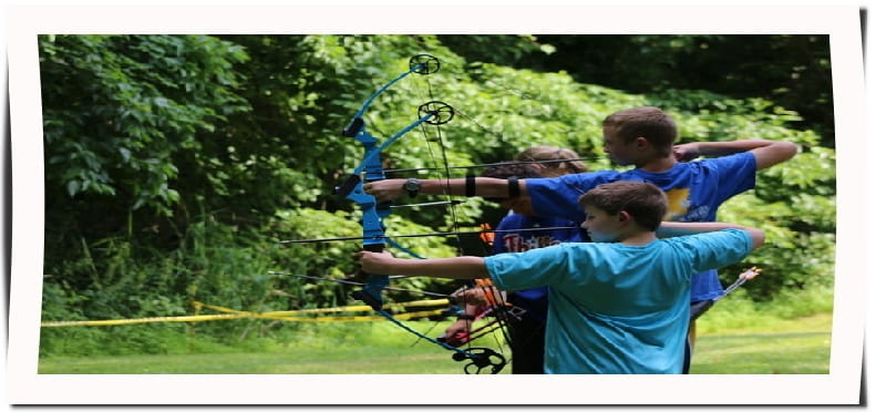 a group of boys shooting bows
