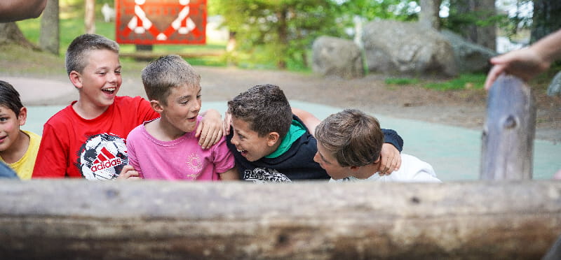 a group of boys sitting on a ledge