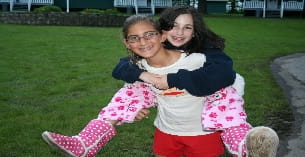 a person hugging a girl in a park