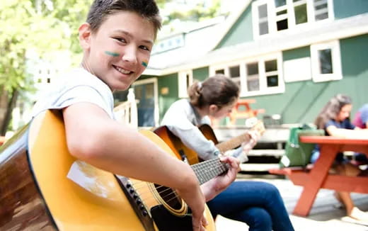 a boy playing a guitar