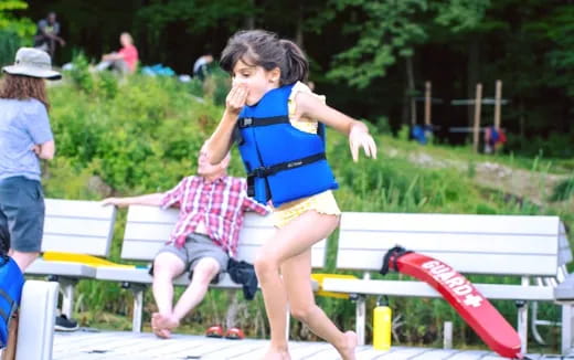 a girl sitting on a bench
