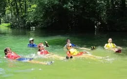 a group of people in a river
