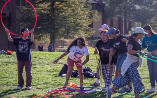 a group of people playing with bows and arrows