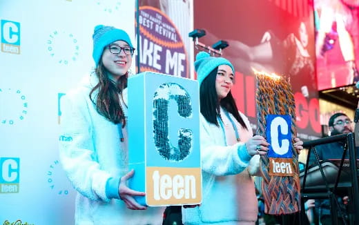 a couple of women holding signs