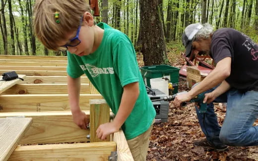 a couple of men building a structure