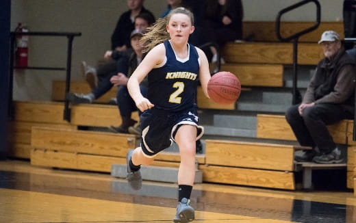 a girl playing basketball