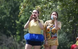 two women singing into microphones